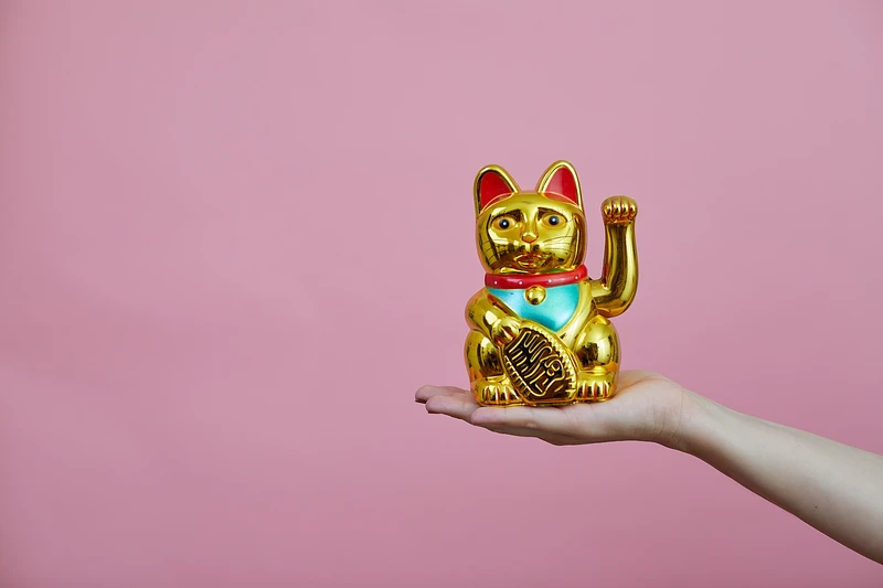 Maneki-neko (招き猫, lit. beckoning cat) brings luck